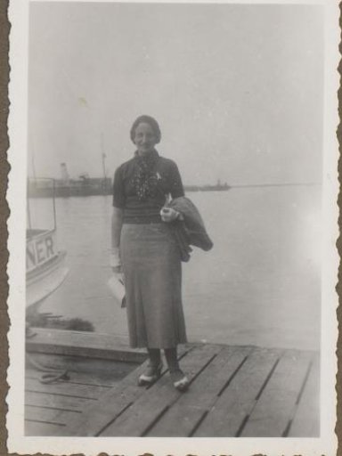Portrait of a Woman Standing by a Harbor