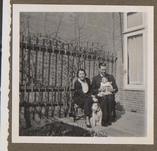 Married Couple with a Child and a Dog in a Garden