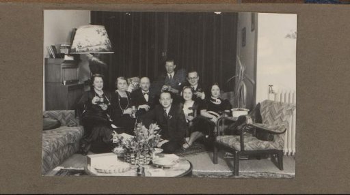 Group portrait of a company at a party in a living room
