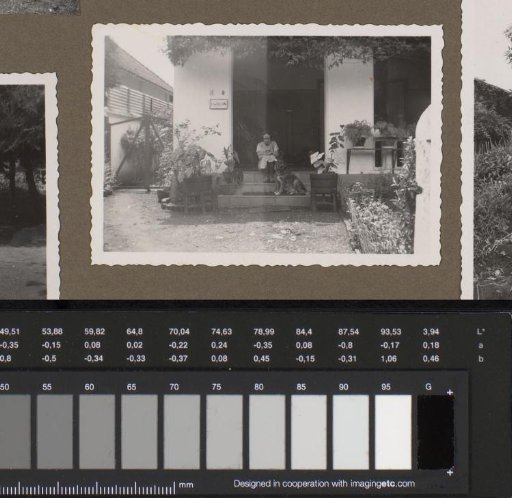 Dootje with a dog sitting in front of her father Hendrikus Johannes van Zijll de Jong's house, Bandoeng