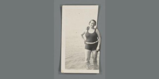 Portrait of an unknown woman standing in a bathing suit in the water