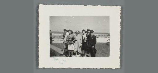 Group portrait of three unknown women and a man along the beach