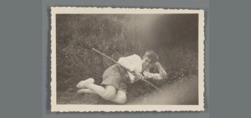 Portrait of an unknown boy lying in the grass