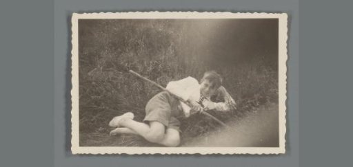 Portrait of an unknown boy lying in the grass
