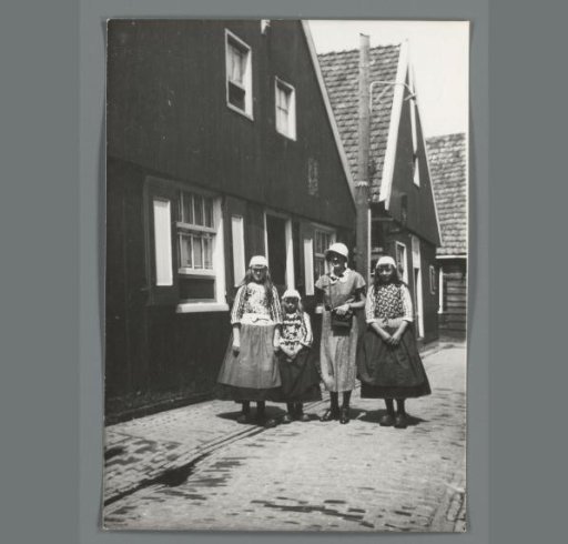 Group portrait of an unknown woman and three unknown girls in Marker costume