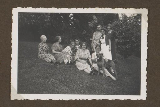 Group portrait of women with a dog in the garden of Villa Mari