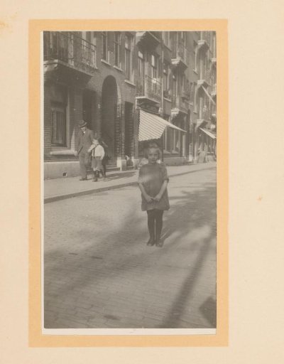 Street view in a Dutch city, with the photographer's shadow in the foreground