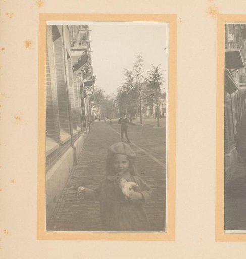 Married couple with child on the street in front of a house