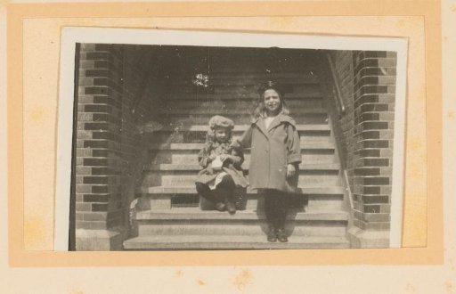Two girls on a stone outdoor staircase