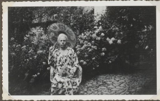 Woman with parasol in the garden of Hotel Roveredo, Switzerland