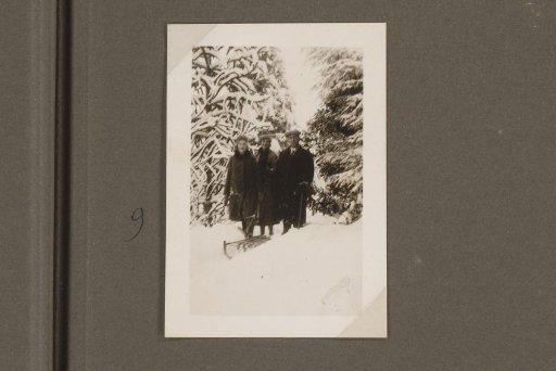 Three members of a family in a snow-covered garden