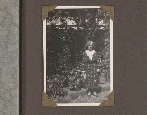 Portrait of a Woman Holding a Bag, Standing in a Garden