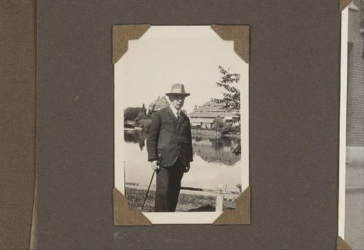 Portrait of a man with a hat and walking stick