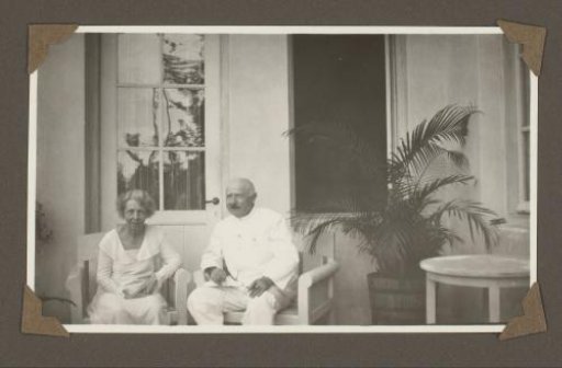 Portrait of a Man and Woman, Seated in Front of a House