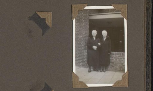 Two Women in Winter Coats, Standing on a Sidewalk