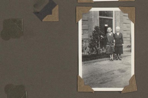 Two Women Standing Before a Fence, Arm in Arm