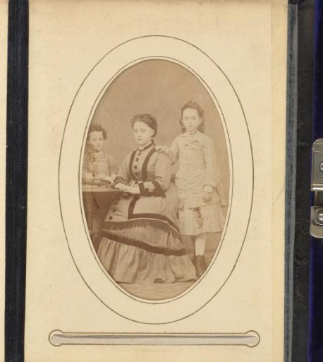 Portrait of a seated woman and two standing girls