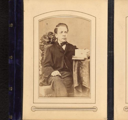 Portrait of a Boy with an Open Book in His Hand, Seated at a Table