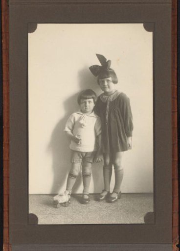 Portrait of Two Children with a Toy Duck