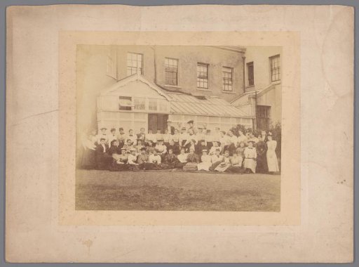 Group portrait of unknown girls, some holding a tennis racket