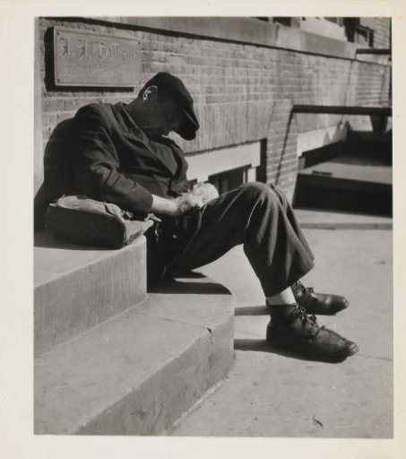 Sleeping man on a sidewalk in Amsterdam