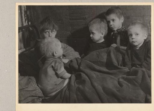 Five children under a blanket