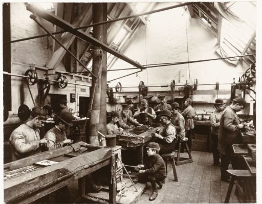Workers around a workbench in a factory