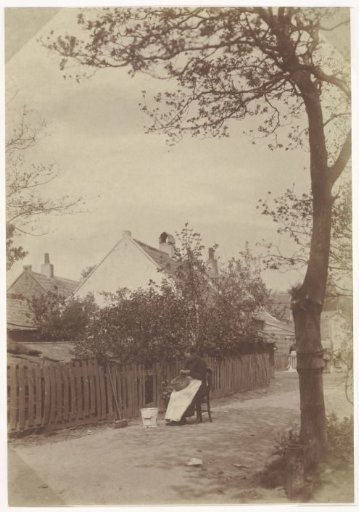 Woman peeling potatoes on the yard
