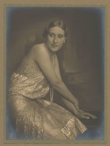 Portrait of Lettie van Lier-van Wijk, mannequin for Hirsch, seated in a dress