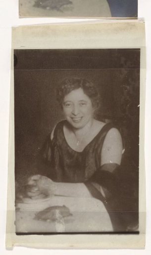 Portrait of an older woman at a table in a gala dress