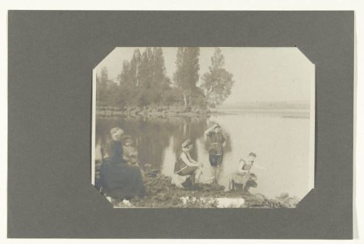 Group portrait of an unknown family by the water in bathing costume