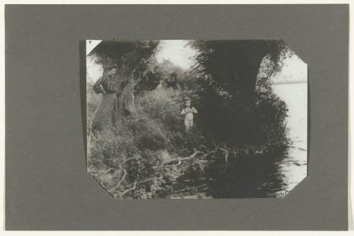 Nude girl with a woman at the water's edge