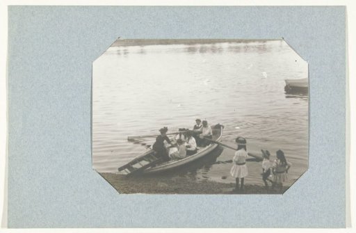 Family in a rowing boat and girls along the bank