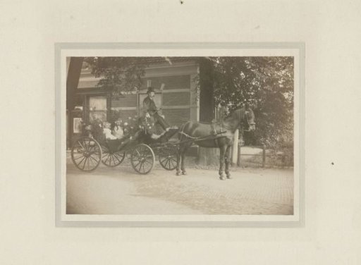 Two Girls in an Ornate Carriage with a Coachman Drawn by a Horse