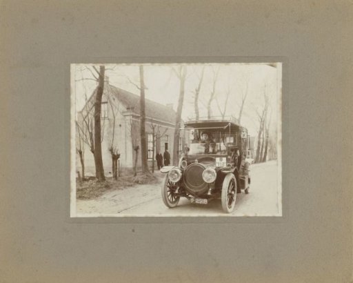 Man in a car near a house