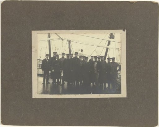 Group portrait of unknown crew on deck of a ship