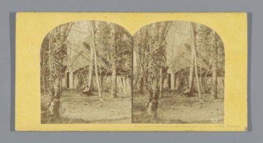 Cottage with a man in front of it in a park in England