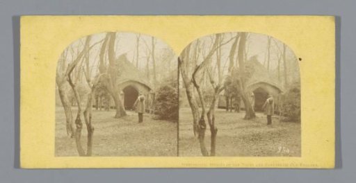 Cottage with a man in front of it in a park in England