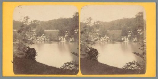 View of a lake and a waterfall in the Bois de Boulogne in Paris