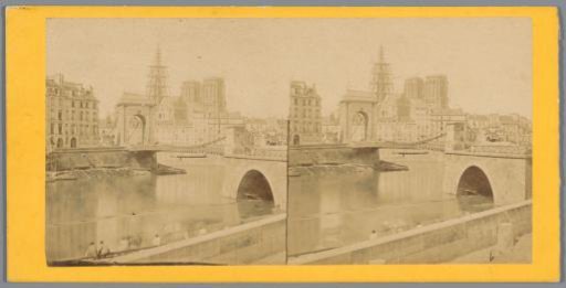View of a bridge with Notre-Dame in Paris with scaffolding behind it