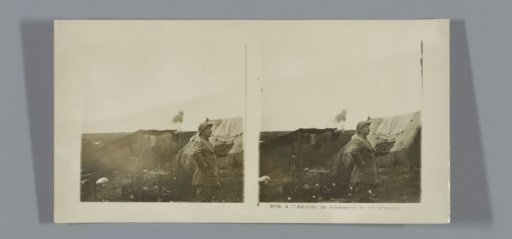 French soldier in front of a tent, with an explosion in the background