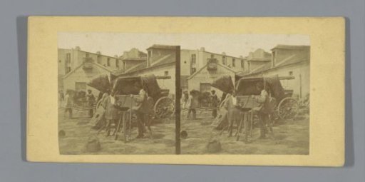 Men on a square in front of a carriage (presumably) in France