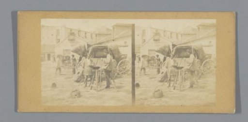 Men on a square in front of a carriage (presumably) in France