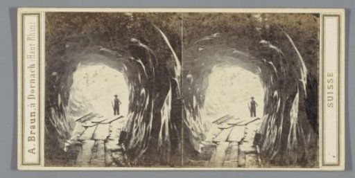 Man at the entrance of a cave in the Upper Grindelwald Glacier or the Lower Grindelwald Glacier, Switzerland