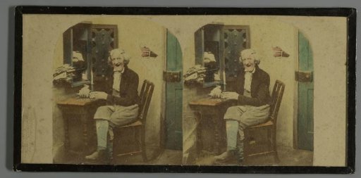 Smiling seated man behind a desk