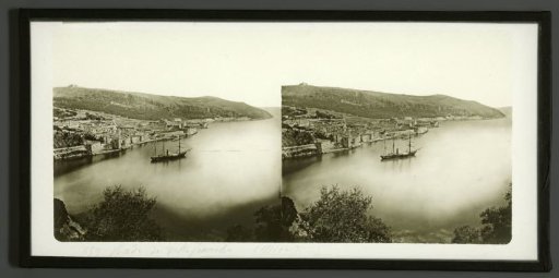 View of Villefranche-sur-Mer, France, with a sailing ship in the foreground