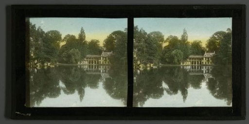 View of Le Hameau de la Reine on a lake in the French garden of the Palace of Versailles