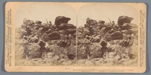View of British soldiers firing from a rocky outcrop at Belmont, South Africa