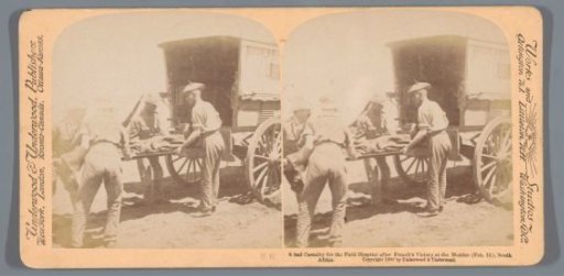 Four soldiers lifting a severely wounded soldier into the back of a carriage at the Modder River, South Africa