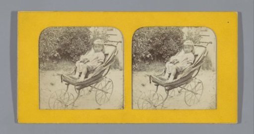 Child with a doll in a pram